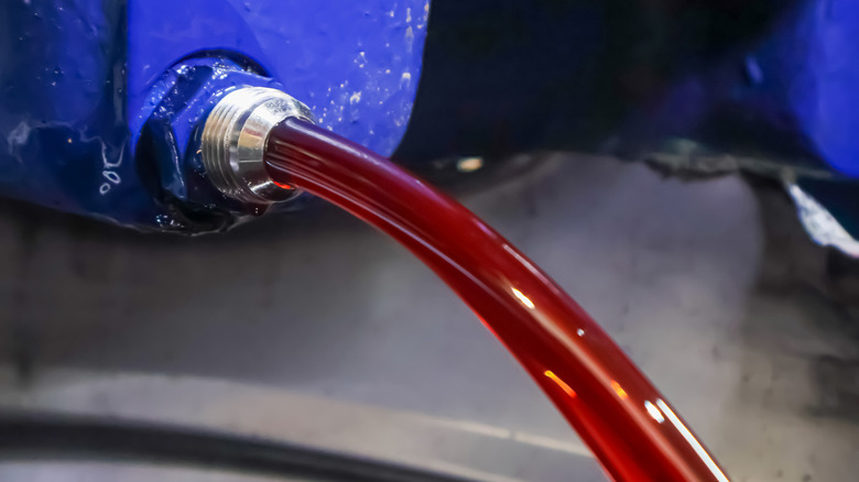 Close up of automatic transmission fluid, a subtype of hydraulic fluid, being pumped through clear lines.