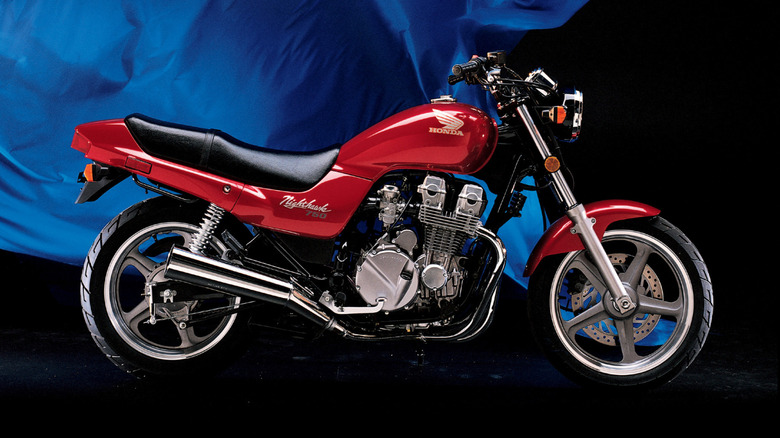 A side view of a red 1991 Honda CB750 Nighthawk
