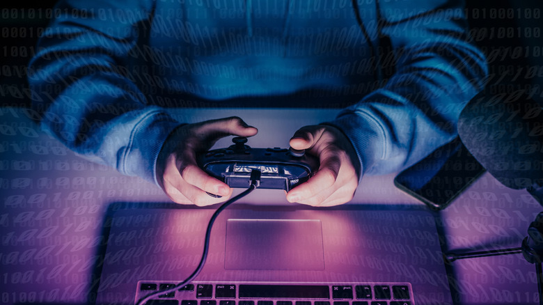 A person holding a controller near keyboard