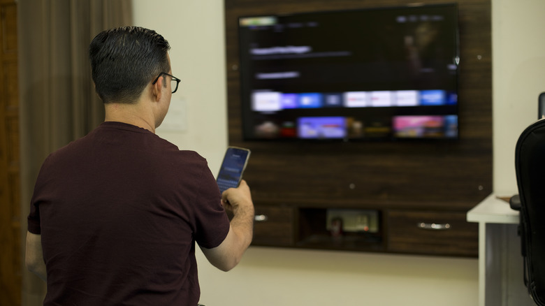 Person casting phone to TV