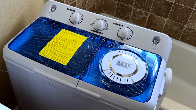 A brand-new semi-automatic washing machine about to be installed