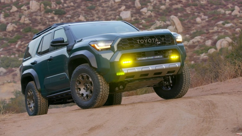 A green 4Runner Trailhunter parked in the wilderness