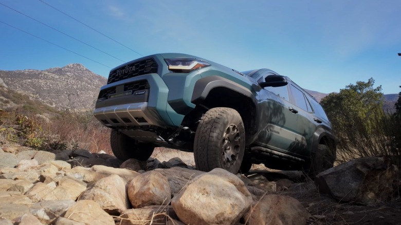 A green 4Runner Trailhunter traversing a rocking trail