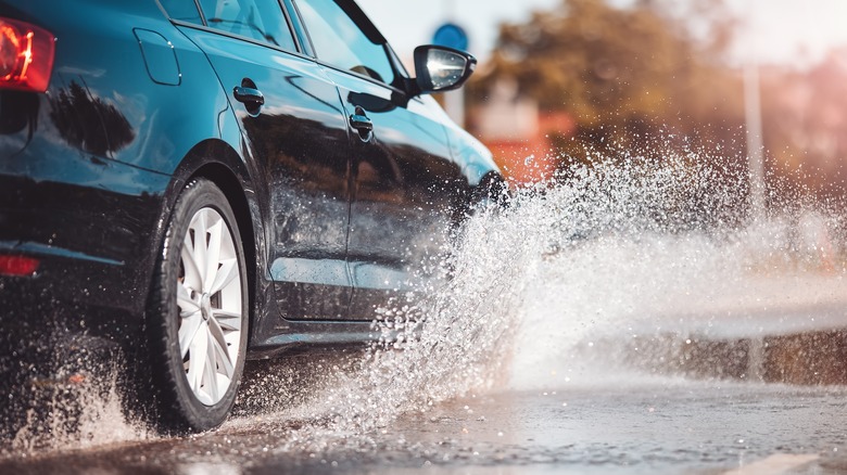 Car driving through a puddle