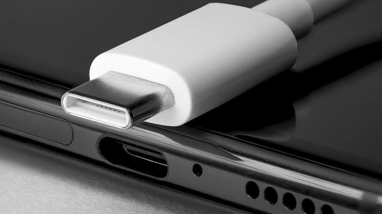 USB-C cable restingon top of black smartphone
