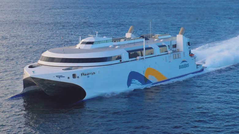 A front 3/4 shot of the HSC Francisco fast ferry performing a crossing at high speed.