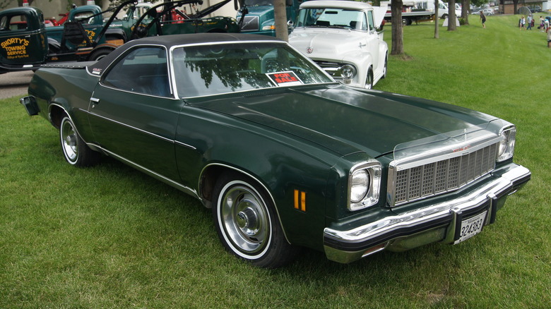 black 1975 GMC Sprint parked in grass at car show