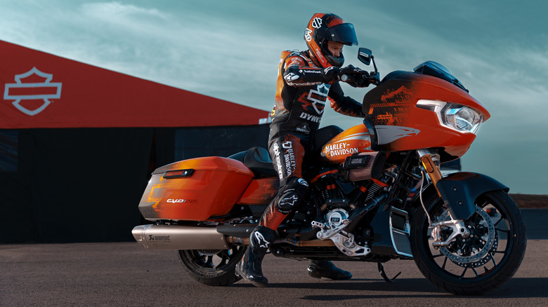 A rider sitting on the 2025 Harley-Davidson CVO Road Glide RR wearing Harley branded racing suit.