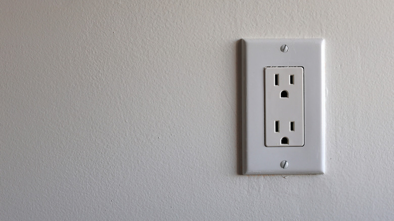 An electrical outlet on a white wall.