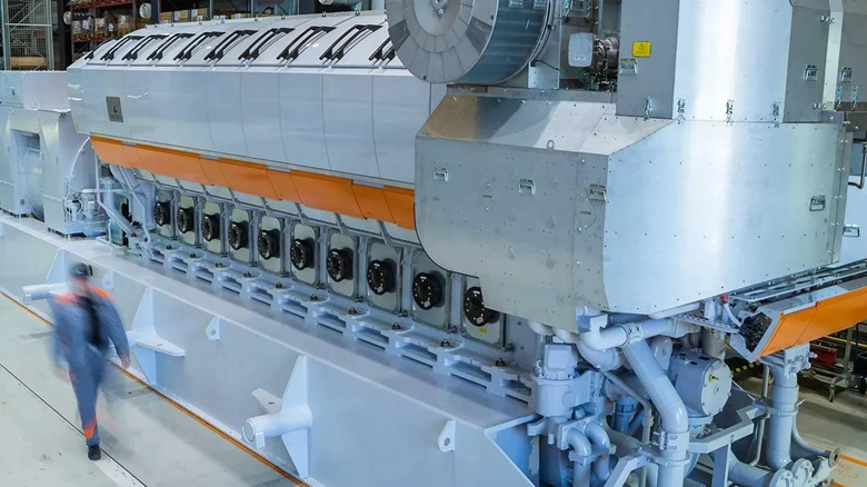 The Wärtsilä 31 engine, higher angle, technician walking past it
