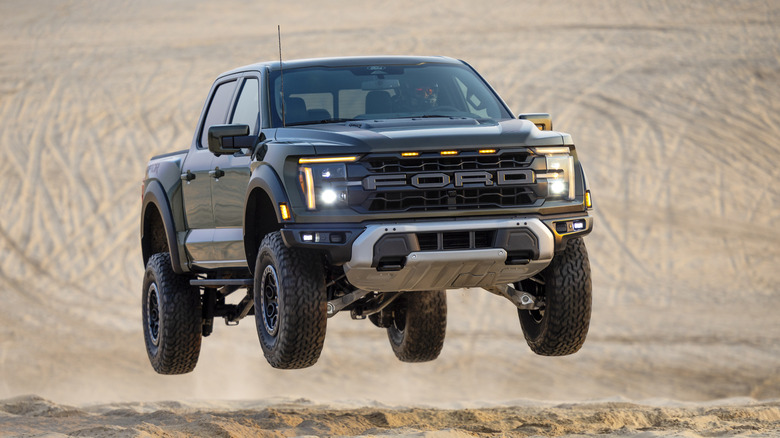 Ford F-150 Raptor jumping over a dune