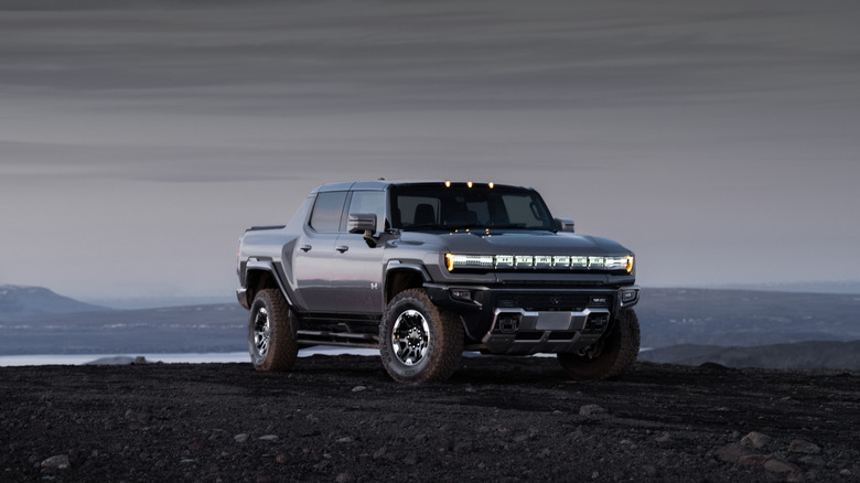 GMC Hummer EV Pickup off-road, front 3/4 view, gray exterior