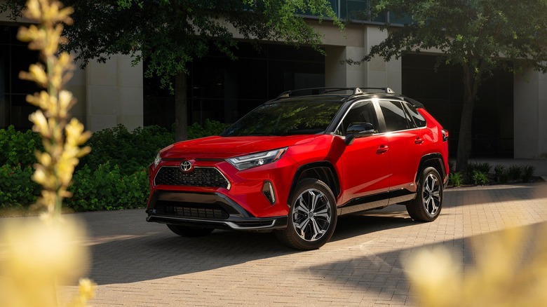 red Toyota RAV4 parked in front of building