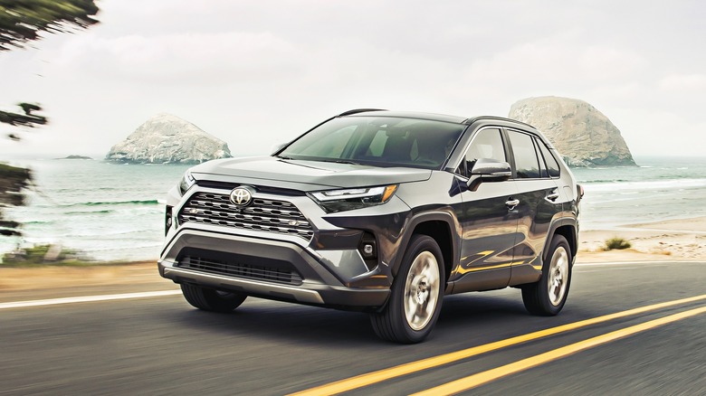 grey Toyota RAV4 driving on seaside road