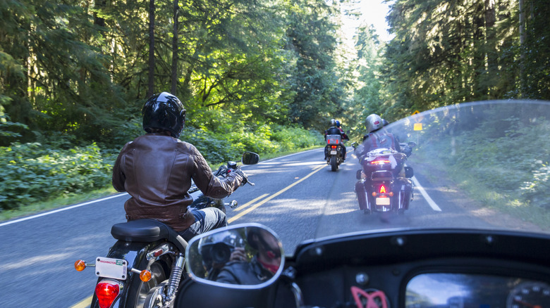 Bikers riding down a road