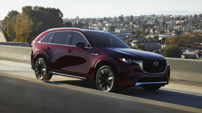 Mazda CX-90 driving on a freeway overpass