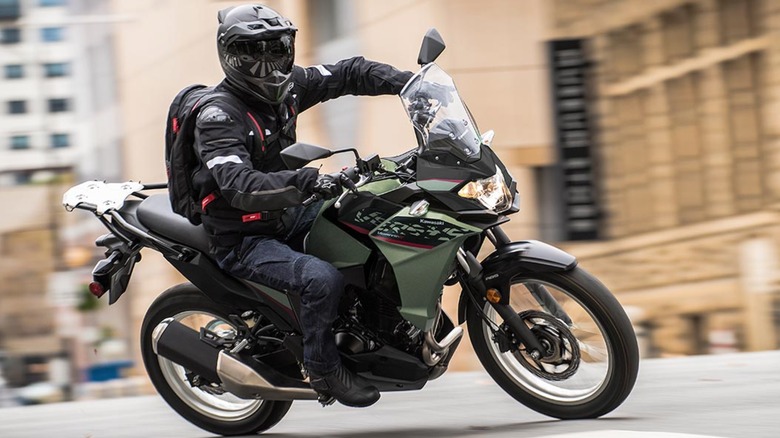 Person turning Kawasaki Versys-X 300 on street