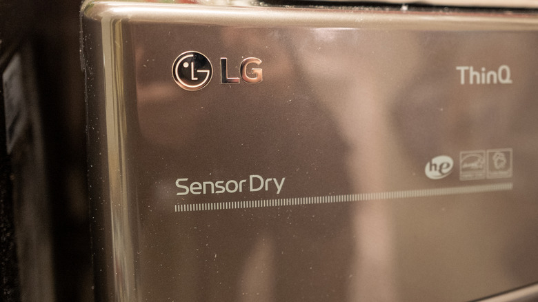 Close-up shot of the LG logo on an LG ThinQ clothes dryer