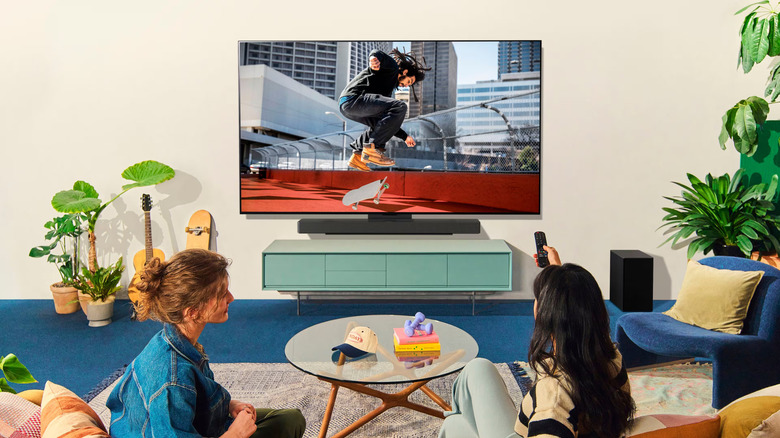 Two people watching an LG C5 OLED TV