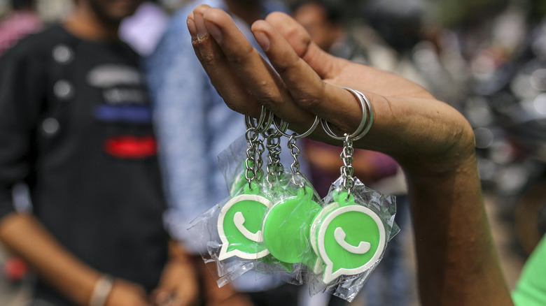 Woman selling WhatsApp keychains.