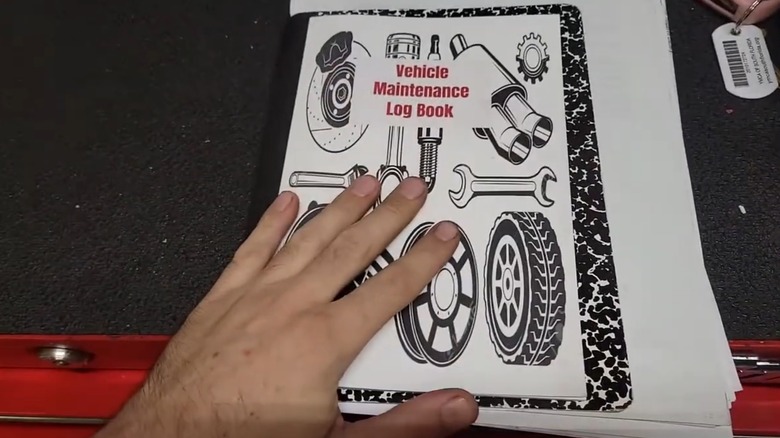 A person showing their vehicle maintenance records