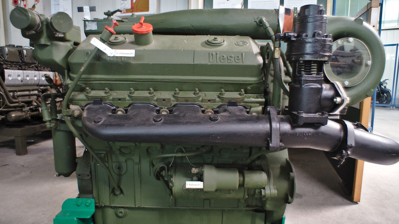 A dusty, green Detroit Diesel 8V71T engine on display