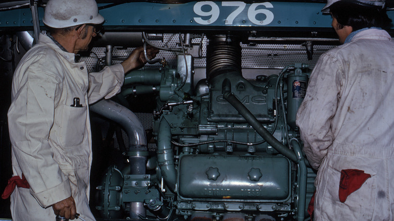 Two specialists examine a 6V71 Detroit Diesel engine
