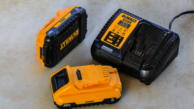 DeWalt 20V batteries on the ground with a charger.