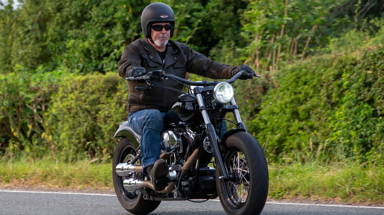 Man riding Harley-Davidson on an empty road