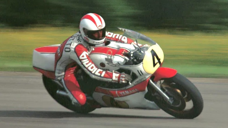 Person riding red and white Yamaha motorcycle on track