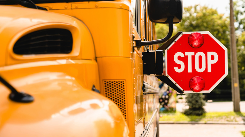 active stop sign on the side of a school bus