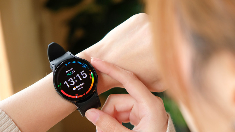 person touching Galaxy Watch