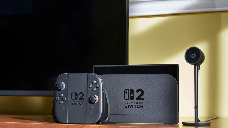 A Nintendo Switch 2 console stood up in front of a TV