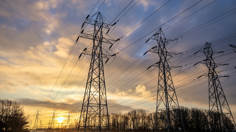 Electric power lines against a sunrise.