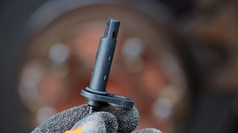 ABS sensor in mechanic's hand