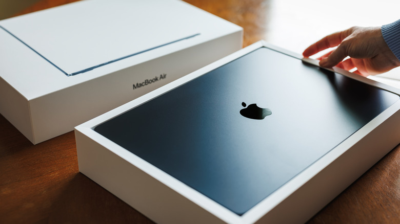 person unboxing a new MacBook Air