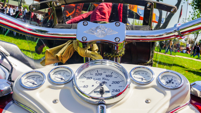 The speedometer of a white Boss Hoss Motorcycle V8 on a vibrant day