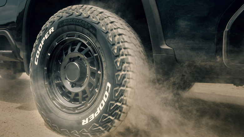 Rear 3/4 view of Cooper Discoverer Stronghold AT tire on Chevy truck