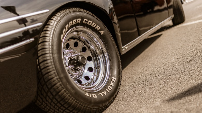 A Cooper Cobra tire on a classic car, chrome steel wheel