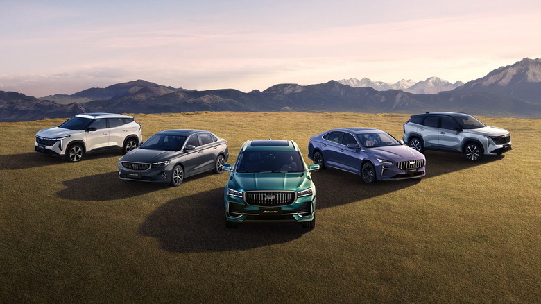Group of Geely vehicles parked on grassy mountaintop