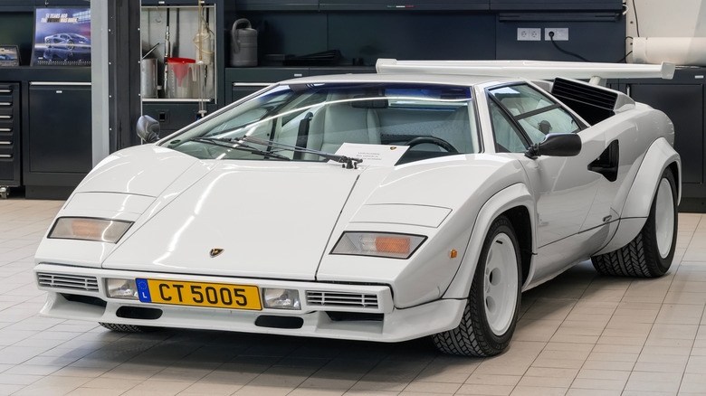 A Lamborghini Countach parked in a shop.