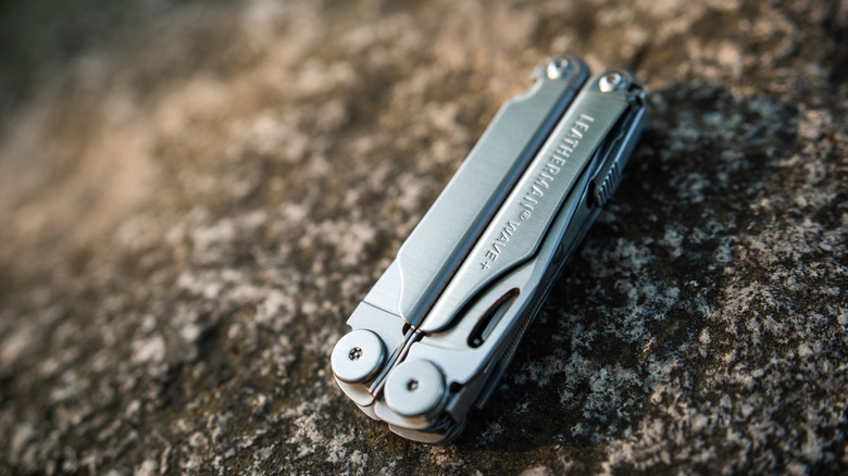 Closed Leatherman Wave tool on a rocky surface.