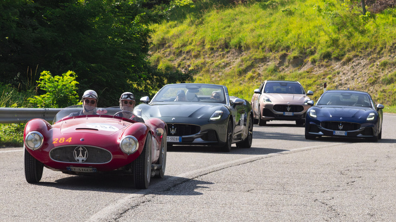 Multiple Maserati vehicles driving on a mountain road