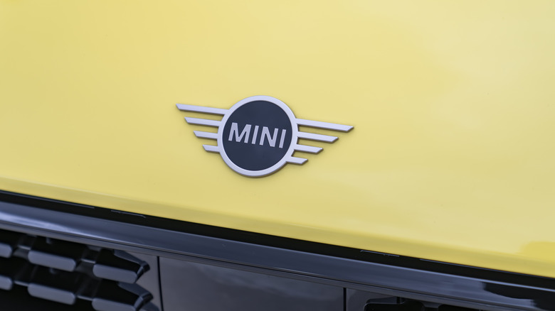 The badge on the front of a yellow 2025 MINI Cooper S