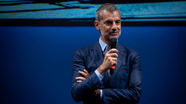 Andrea Casaluci CEO of Pirelli holding a mic