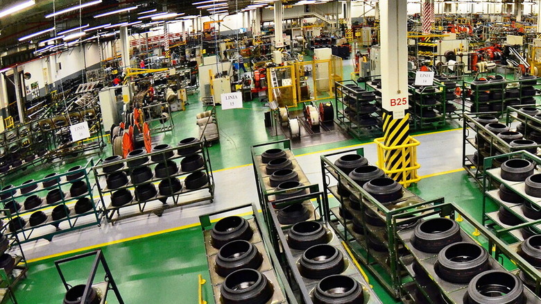 Inside Pirelli manufacturing plant in Romania showing multiple racks of tires