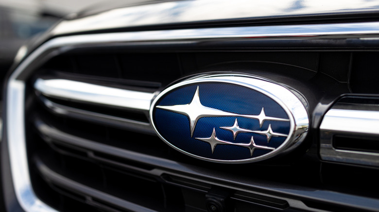 Close up of Subaru logo on a shiny car grille