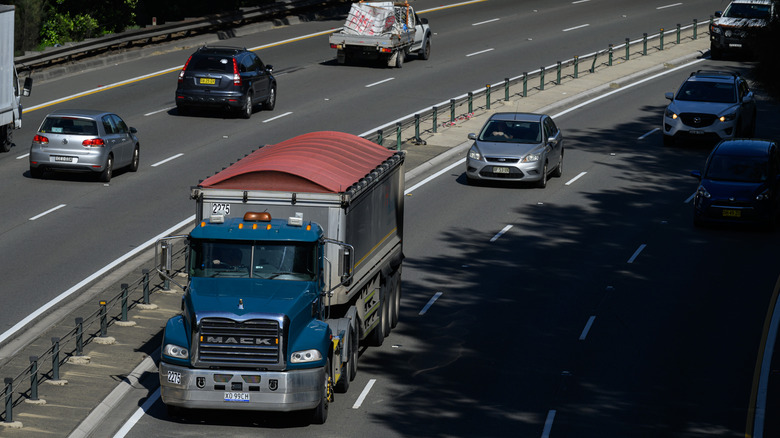 Commuters on highway with semi truck