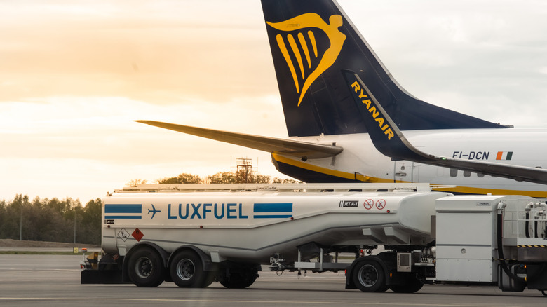 Fuel truck beside airplane
