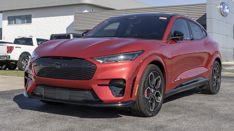 Red Ford Mach-E Mustang GT SUV parked in front of a Ford building